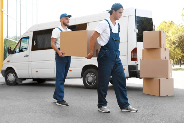 depositphotos_211440724-stock-photo-male-movers-unloading-boxes-van